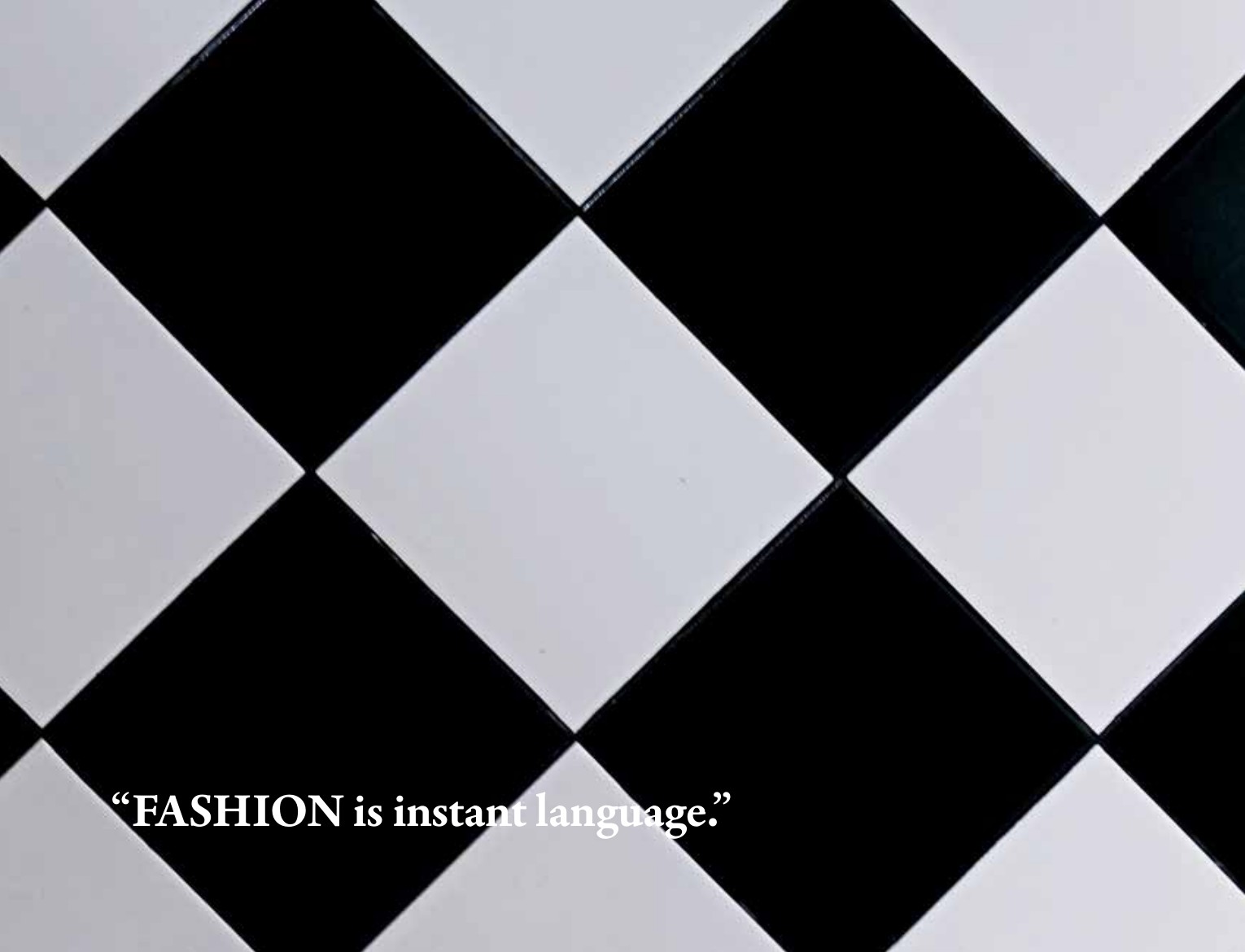 Prada editorial closing page with a black-and-white diamond pattern and the quote Fashion is instant language.