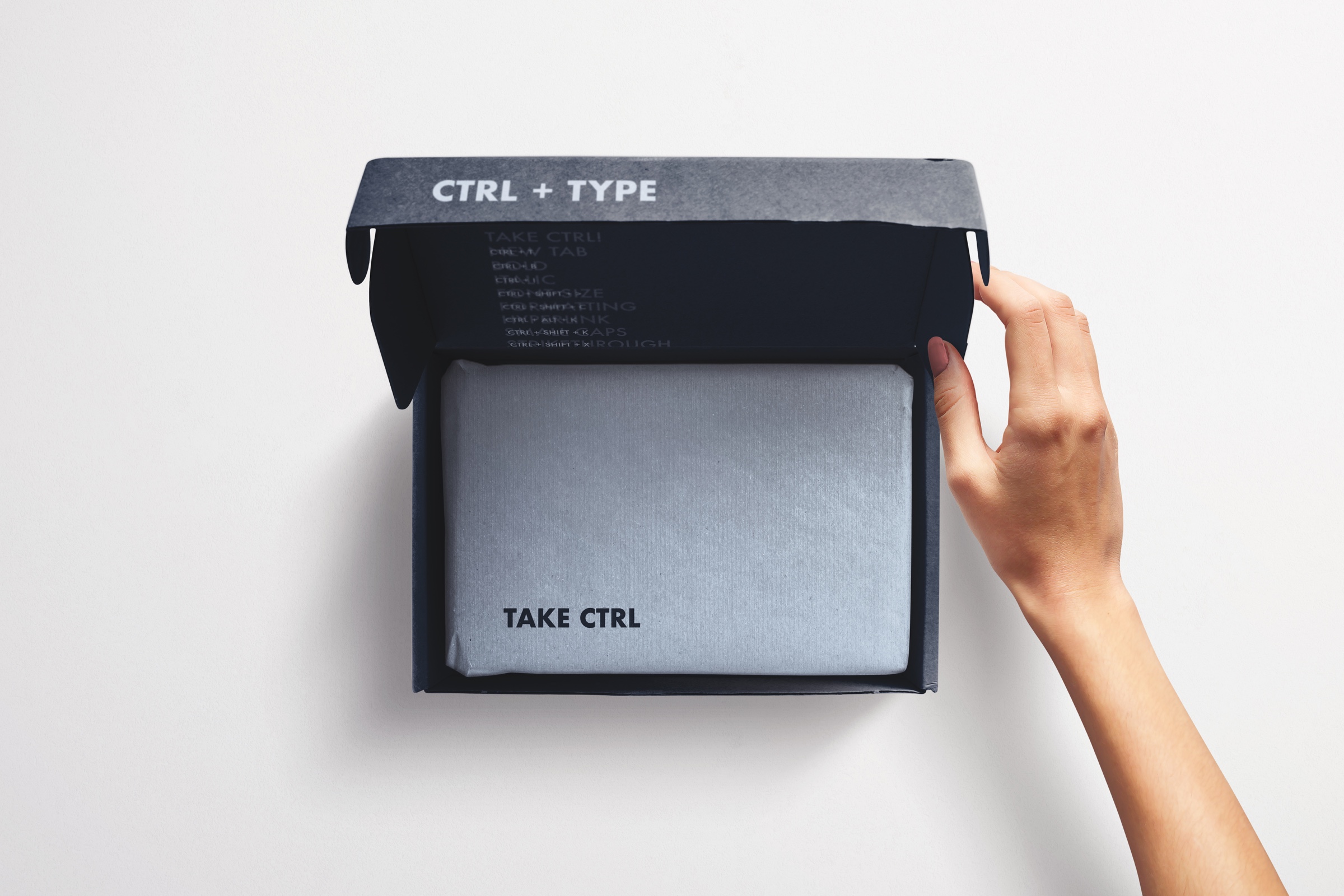 Open dark exhibition packaging box featuring CTRL + TYPE and Take CTRL messaging.